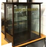 A Mahogany Shop Display Cabinet with advertising stencilling, 65cm by 37cm by 75cm