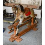 An Early 20th-Century Childs Dapple Grey Rocking Horse, on trestle base, 97cm high (in need of