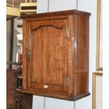 An Early 19th Century Oak Hanging Cupboard with moulded panel door, 62cm by 29cm by 74cm