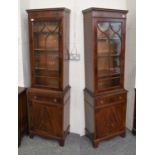 A Pair of Reproduction Mahogany Display Cabinets, the glazed upper section above a drawer and