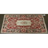 A Chinese Needlepoint Rug, of Aubusson design, the cream field with central floral medallion