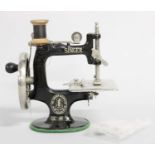 Miniature Singer Sewing Machine, with three reels of cotton, 17cm high Mechanism appears to be