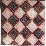 Circa 1900 American Windmill Blade Log Cabin Quilt, incorporating printed and plain red cottons