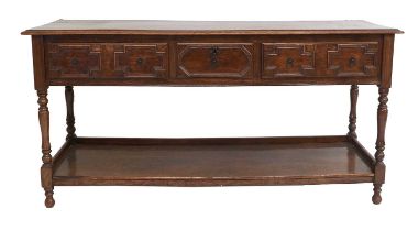 An Oak Geometric-Moulded Dresser Base, the moulded top above two conforming two-as-one pine-lined
