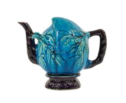 A Chinese Turquoise and Aubergine-Glazed Cadogan Teapot, Qing Dynasty, modelled as a peach with