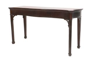 A George III Mahogany Serpentine Serving Table, circa 1800, the moulded top above a fluted frieze