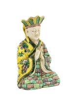 ~ A Chinese Porcelain Figure of an Aesthetic, Kangxi, seated crossed legged, his hands in prayer,