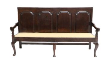 ~ A George III Joined Oak Settle, late 18th century, the moulded top rail above four fielded