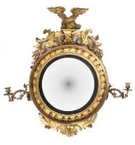 A Regency Carved Giltwood Convex Mirror, early 19th century, with ebonised slip and ball-