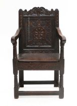 A Late 17th Century Joined Oak and Carved Wainscot Armchair, probably Scottish, the top rail