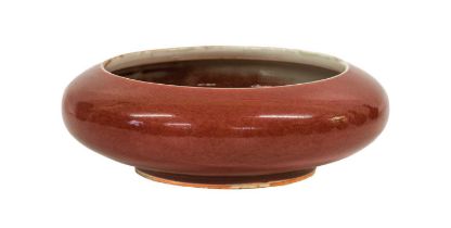 A Chinese Sang de Boeuf- Glazed Porcelain Bowl, Qing Dynasty, of compressed globular form 22.5cm