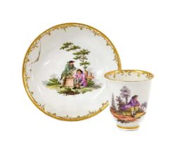 A Vienna Porcelain Coffee Cup and Saucer, circa 1770, painted with peasants in landscape within gilt