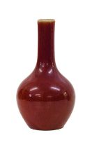 A Chinese Sang de Boeuf Porcelain Bottle Vase, Qing Dynasty, of ovoid form with tall cylindrical