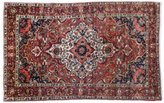 Bakhtiari Rug West Iran, circa 1930 The blood red field of vines and palmettes centred by an ivory