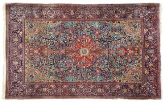 ~ Kashan Rug Central Iran, circa 1930, the deep indigo field of leafy vines around a brick red