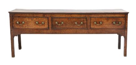A George III Oak Dresser, late 18th century, the moulded two-plank top above three pine-lined