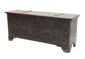 A 17th Century Oak Chest, the moulded lid with iron hinges enclosing a vacant interior above a