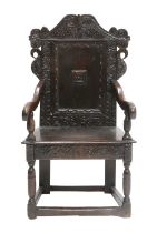 A 17th Century Joined Oak Wainscot Chair, probably Yorkshire/Leeds, the top rail carved with scrolls