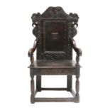 A 17th Century Joined Oak Wainscot Chair, probably Yorkshire/Leeds, the top rail carved with scrolls