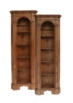 A Matched Pair of George III-Style Pine Alcove Corner Cupboards, one 19th century, the other
