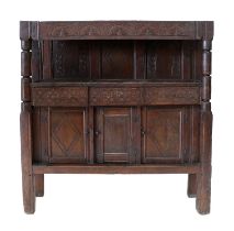 A Joined Oak Food Cupboard, the panelled top above a lunette-carved frieze on turned and barrel