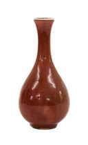 A Chinese Sang de Boeuf Glazed Porcelain Vase, Qing Dynasty, of pear shape with slightly flared