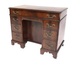 A George III Mahogany Kneehole Desk, circa 1780, the crossbanded moulded top above seven pine-