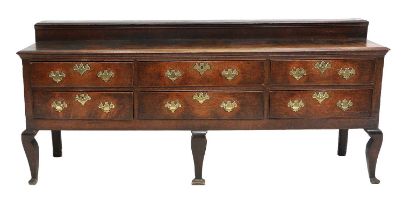 A George III Oak Enclosed Dresser, late 18th century, the staged back and moulded top above six