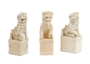 A Matched Pair of Blanc de Chine Porcelain Figures of Dogs of Fo, Kangxi, of typical form, each with