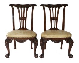 A Pair of Irish George II-Style Carved Mahogany Dining Chairs, 20th century, covered in close-nailed