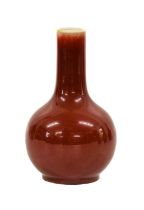 A Chinese Sang de Boeuf Glazed Porcelain Bottle Vase, Qing Dynasty, of ovoid form with tall
