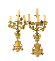 A Pair of Gilt Metal Four-Light Candelabra, in Louis XVI style, with foliate scroll branches issuing