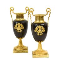 A Pair of Gilt and Patinated Bronze Urns, in Empire style, with twin serpent and wreath handles, the