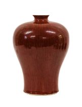 A Chinese Sang de Boeuf Glazed Porcelain Meiping Vase, Qing Dynasty, of baluster form with everted