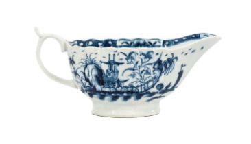A Worcester Porcelain Sauceboat, circa 1765, of fluted oval form, painted in underglaze blue with