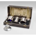 A George V Cased Silver Condiment-Set, each piece drum shaped and with reeded rims, in fitted