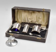 A George V Cased Silver Condiment-Set, each piece drum shaped and with reeded rims, in fitted