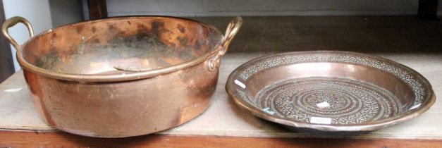 A 19th Century Twin Handled Copper Pan; together with a middle eastern copper dish