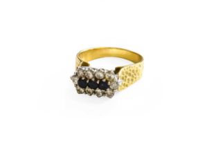 An 18 Carat Gold Sapphire and Diamond Triple Cluster Ring, the round cut sapphires within a border