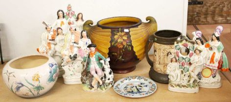 A Bristol Polychrome Delft Plate, 18th century, seven Victorian Staffordshire figures, a Bretby