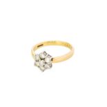 A 9 Carat Gold Diamond Cluster Ring, the central raised round brilliant cut diamond within a