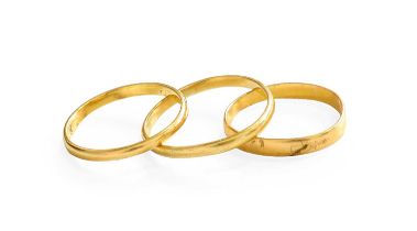 Two 22 Carat Gold Band Rings, finger sizes I and K; and Another Band Ring, stamped ‘18’, finger size