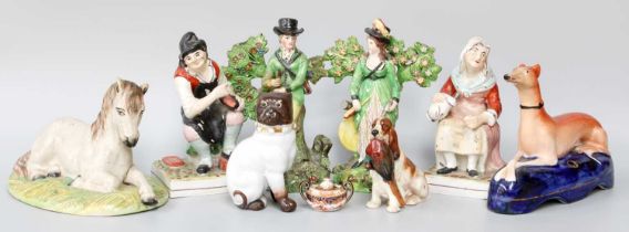 A Pair of Early 19th century Pearlware Figuresof a Hunter and Companion, together with other