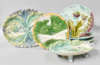 A Set of Eight 19th Century French Faience Asparagus and Artichoke Plates, each stamped "Luneville";