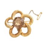 A 9 Carat Gold Smoky Quartz Brooch, the round cut smoky quartz in a yellow claw setting, to an