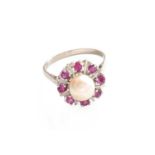 A Cultured Pearl and Synthetic Ruby Cluster Ring, the cultured pearl within a border of round cut