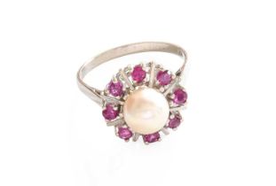 A Cultured Pearl and Synthetic Ruby Cluster Ring, the cultured pearl within a border of round cut