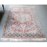 Pink Indian Rug, the pink field with a central medallion enclosed by compartmentalised borders,