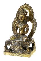A Sino-Tibetan Bronze Figure of Buddha, in 17th century style, seated cross-legged before a