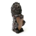 A Carved Oak Heraldic Lion, 18th century, possibly a newal post finial, modelled holding a vacant